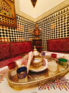 a tray with a tea pot on a table at Riad dar Kirami in Fès