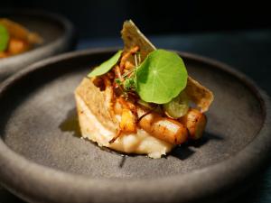 a piece of food on a gray plate at Ölme Prästgård Gästgiveri in Kristinehamn