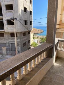 a balcony of a building with a view of the ocean at Appartement vue sur mer - Al Hoceima in Al Hoceïma
