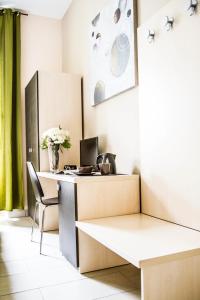 an office with a desk with a computer and a chair at Mosaic Central Guest House in Rome