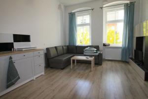 a living room with a couch and a tv at Ali4 in Sosnowiec