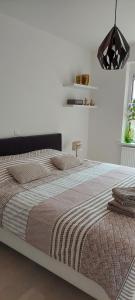 a bedroom with a large bed in a room at Vakantie-appartement La Régence @ Oostende in Ostend