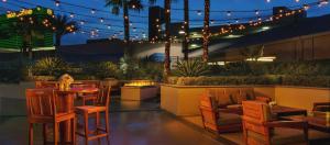 a patio with a table and chairs and lights at StripViewSuites Penthouse Two-Bedroom Conjoined Suite in Las Vegas