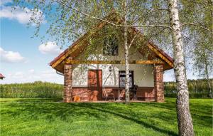 a tiny house on a green field with trees at Pet Friendly Home In Gubin With Sauna in Gubin