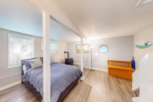 a bedroom with a bed and a window at Singing Winds in Port Orford