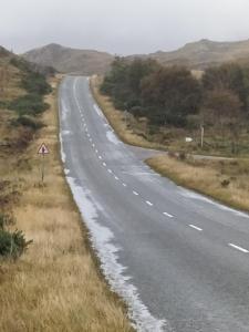 an empty road in the middle of a field at Lavender hut in Brackloch