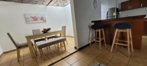 a kitchen with a table and two stools and a counter at Apartamento Centro San Andrés Islas #4 in San Andrés +26 photos