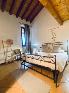 a bedroom with a bed in a room with wooden ceilings at Gabriel’s Home in Salò +43 photos