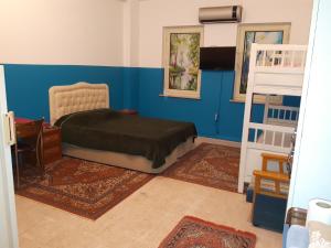 ein Schlafzimmer mit blauen Wänden und einem Bett und einer Leiter in der Unterkunft mai AK pansiyon in Çınarcık