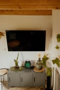 a flat screen tv on a wall above a table at Lipa pod groniem in Ustroń
