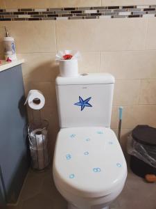 a bathroom with a toilet with a starfish on it at Desired View in Choiseul