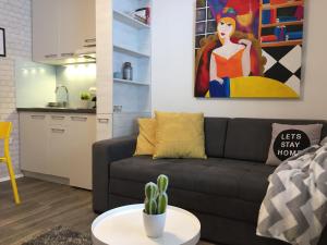 a living room with a couch and a cactus at MONI Luxury Apartments in Kopaonik