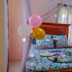 a group of balloons sitting on a bed at Desired View in Choiseul