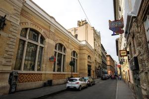 a street with cars parked on the side of a building at A37 Awesome Apartments in Budapest