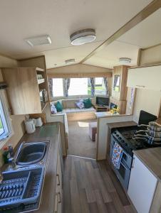 a kitchen and living room of a caravan at The Jones's Family Caravan with private decking - Presthaven in Prestatyn