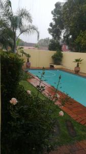 a swimming pool in the yard of a house at The Sanctuary Penthouse in Plettenberg Bay