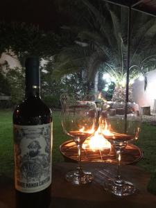 a bottle of wine and two glasses on a table at Departamento PRINGLES - con cochera in La Rioja