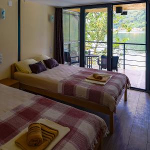 2 camas en una habitación con vistas al agua en VILA SMARAGD en Zvornik