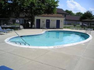 a large swimming pool in the middle of a patio at 2 Bedroom Condo in Rehoboth Beach w/ New Bed in Rehoboth Beach