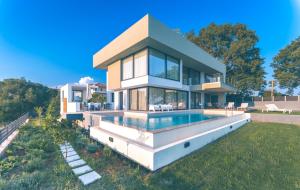 a house with a swimming pool in front of it at Villa Pausilypon in Preveza