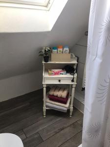 a small white table with towels on it in a bathroom at Maya's Place in Leverkusen