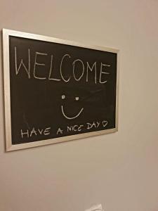 a sign that says welcome have a nice day at Vistula studio in Warsaw