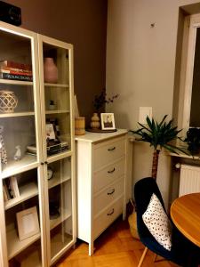 a room with a white cabinet and a table and a desk at Vistula studio in Warsaw