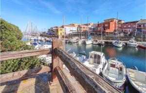 a group of boats docked in a marina with buildings at 3 Bedroom Amazing Home In Stintino in Stintino