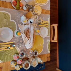 a table with plates and dishes on a table at B&B Gästehaus Rössli Schwellbrunn in Schwellbrunn