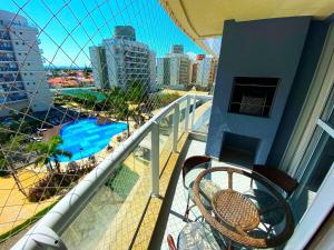 a balcony with a view of a pool and buildings at Nautilus Home Club - Penha - SC in Penha