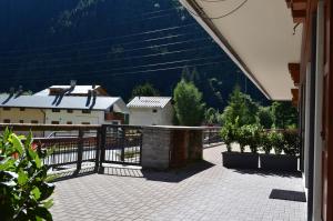 a balcony with a fence and some plants at Appartamenti Sky Express in Campodolcino