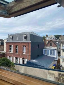 a view from a window of a brick building at La petite Marcotte in Étretat