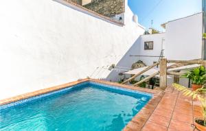 a swimming pool in the backyard of a house at Pet Friendly Home In Hornachuelos With Kitchen in Hornachuelos