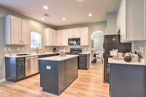 a large kitchen with stainless steel appliances and white cabinets at Family Home, 23Mi to DWTN Atlanta and Aquarium in Stockbridge