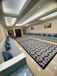 una grande stanza con divani e sedie in un edificio di The Fort Farm a Suḩaybah