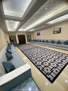 a large room with couches and chairs in a building at The Fort Farm in Suḩaybah +24 photos