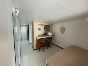 a room with a kitchen and a counter with stools at Pipas Bay - FLAT VISTA MAR in Pipa