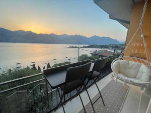 a balcony with chairs and a view of the water at Ferienwohnung Malcesine ,Val di Sogno - Gardasee Italien in Malcesine