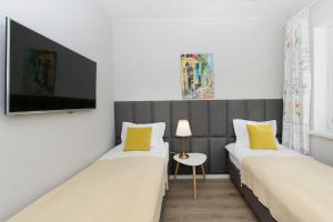 Televízia a/alebo spoločenská miestnosť v ubytovaní Słoneczne Tarasy II - Apartments