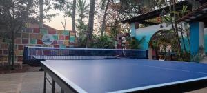 a blue ping pong table in a yard with at Beachside in Anjuna