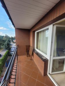 a balcony of a house with a window at Dom gościnny Monika in Pobierowo