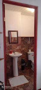 a bathroom with a sink and a toilet at Hotel Your House in Alajuela City