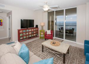 a living room with a couch and a tv at Beach Colony East 12C in Pensacola