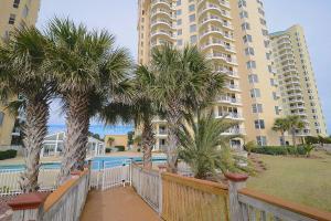a balcony with palm trees in front of a building at Beach Colony East 12C in Pensacola