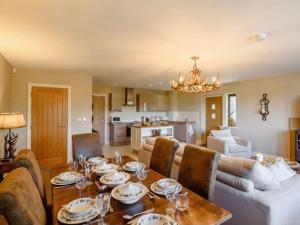 a dining room with a table and a living room at The Haven in Barlow