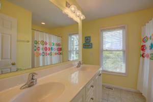 a bathroom with two sinks and a large mirror at Surf and Sound in North Topsail Beach +14 photos