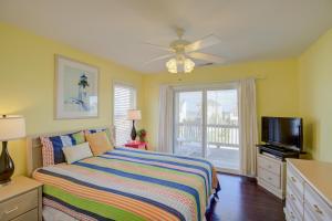 a bedroom with a bed and a flat screen tv at Surf and Sound in North Topsail Beach
