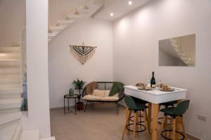 a living room with a table and chairs at The Olive 3 - Traditional Maltese Accommodation in Vittoriosa