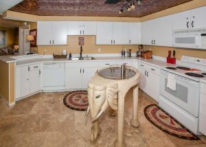 a kitchen with a table in the middle of it at The Palms 313A in Orange Beach