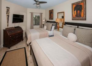 a bedroom with two beds and a flat screen tv at The Palms 313A in Orange Beach +42 photos